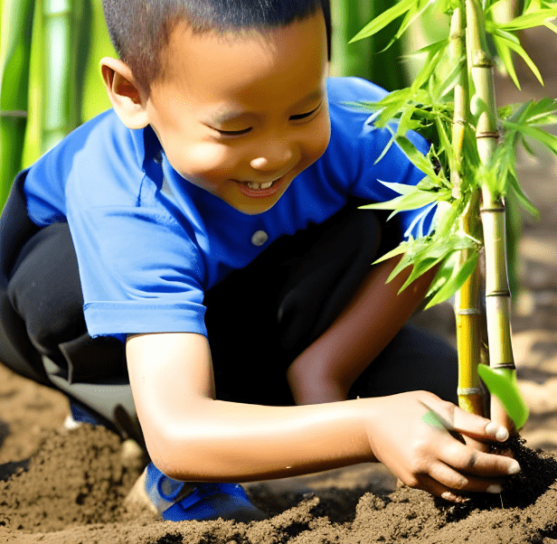 little boy planting bamboo and smiling