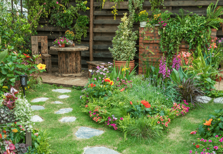 pathway through a small garden with a flower border