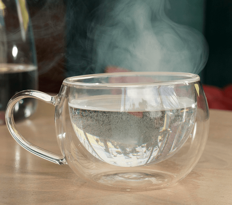 clear glass cup with steaming water